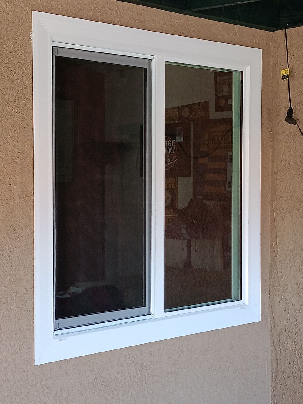 Modern double-pane window with white frame in an exterior wall.