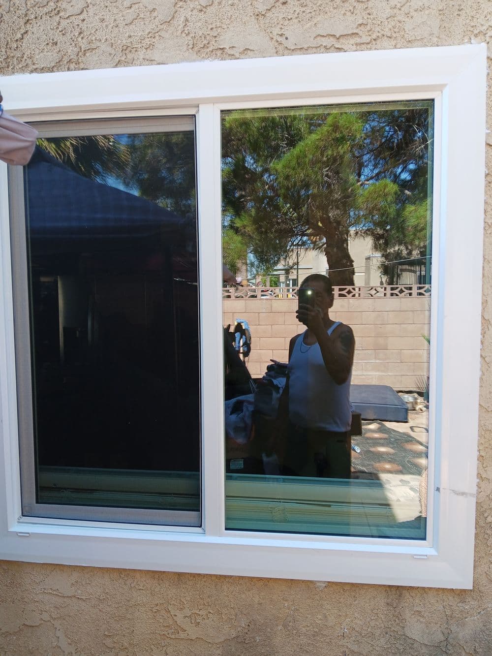 Modern vinyl window reflecting a person, set against an outdoor background. Elegant and functional.