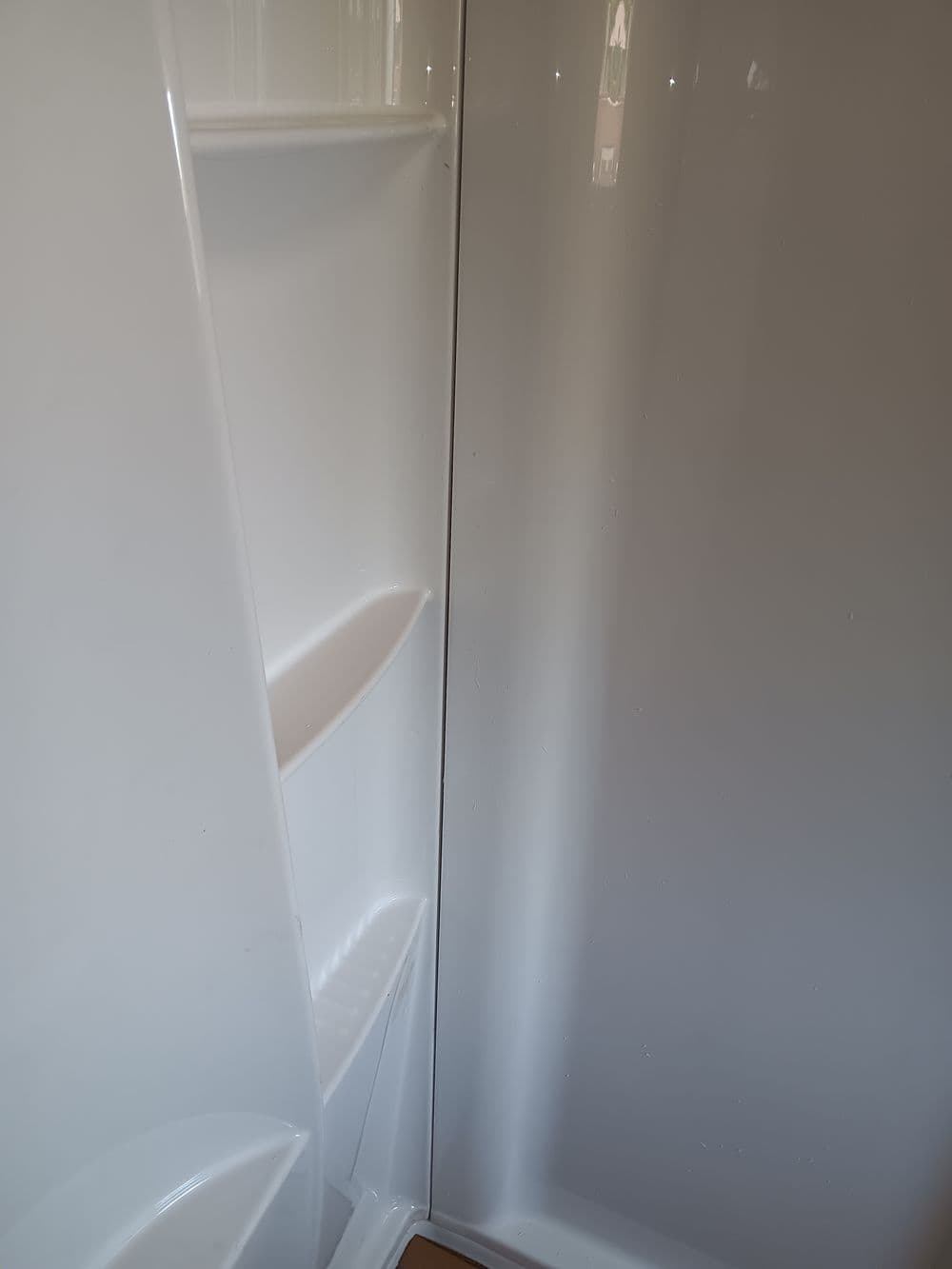 Clean white refrigerator interior showcasing shelves and storage spaces.